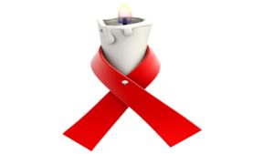 red ribbon tied around burning candle
